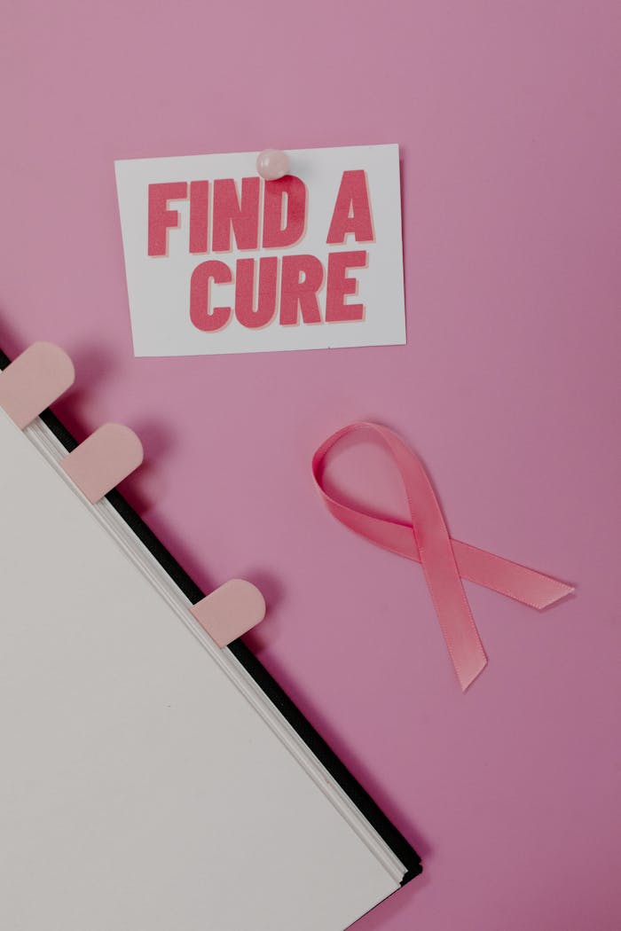 services-02 Pink ribbon and 'Find a Cure' card symbolizing cancer awareness on a pink background.